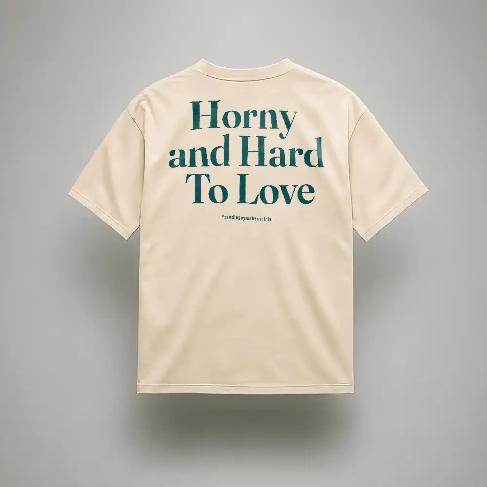 Beige T-shirt with teal slogan on the back reading 'Horny and Hard To Love'.