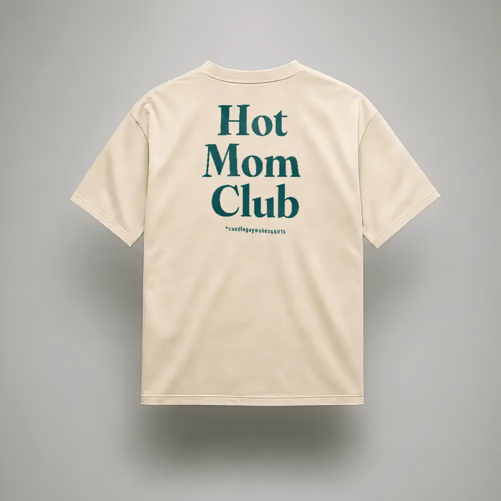 Beige t-shirt shown from the back with bold teal text: 'Hot Mom Club' and small asterisked line underneath