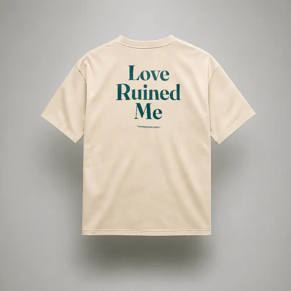 Beige short-sleeve T-shirt showing teal text on the back: “Love Ruined Me” with small text underneath.